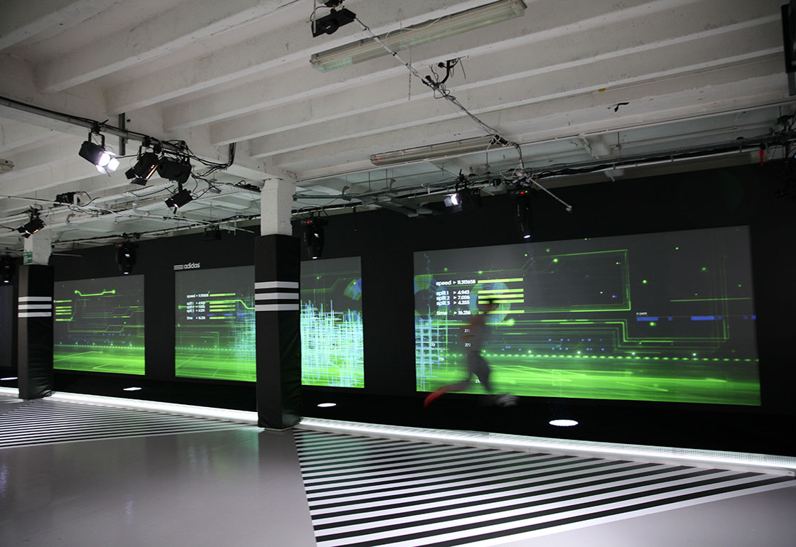 Projection screens in a basement and a runner in front of them