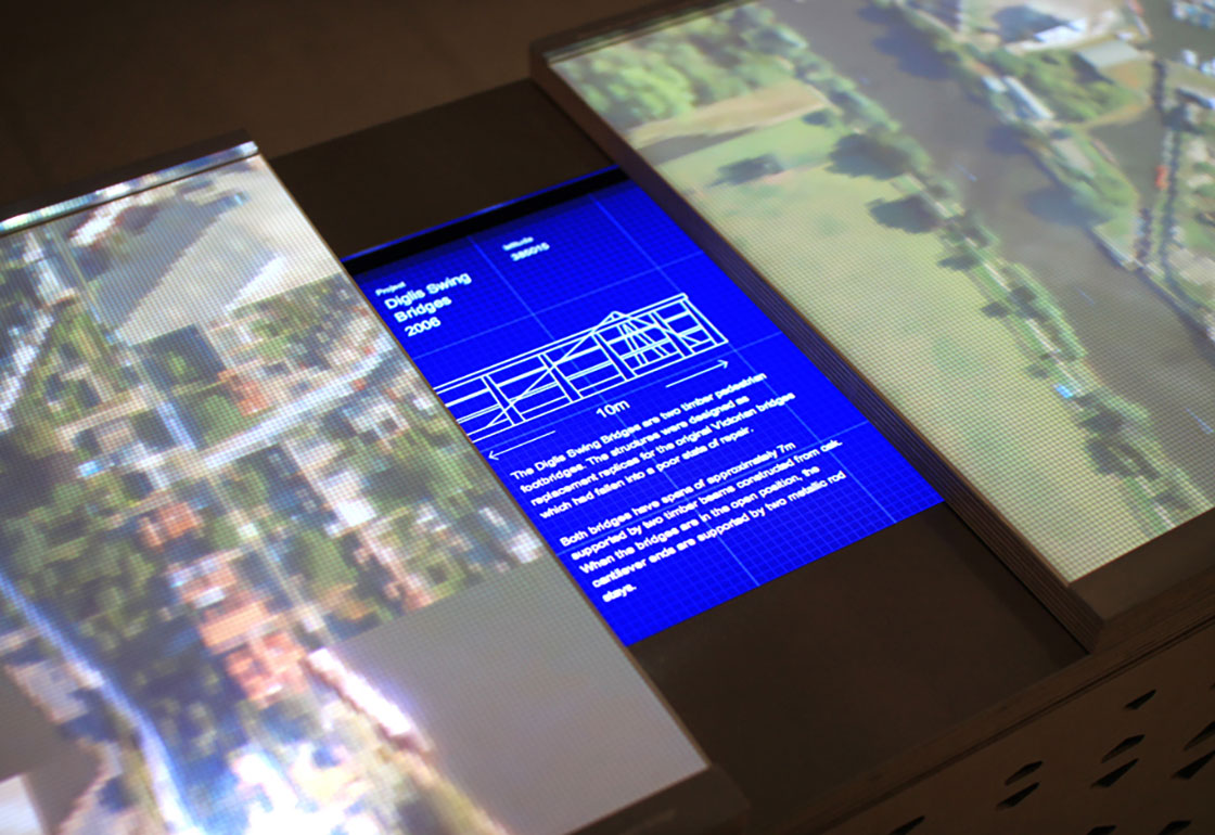 A screen showing a blue print with projected map on either side