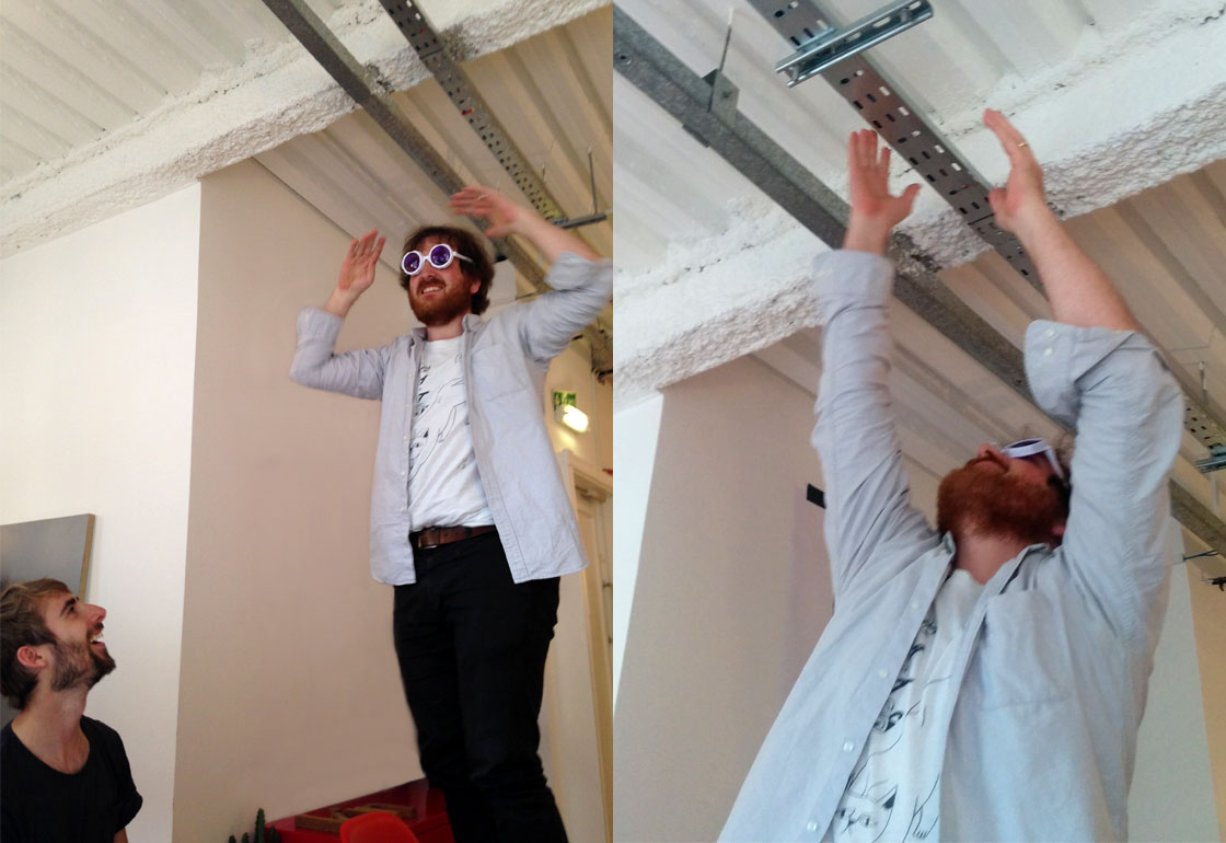 Man with refraction glasses standing on a chair arms outstretched