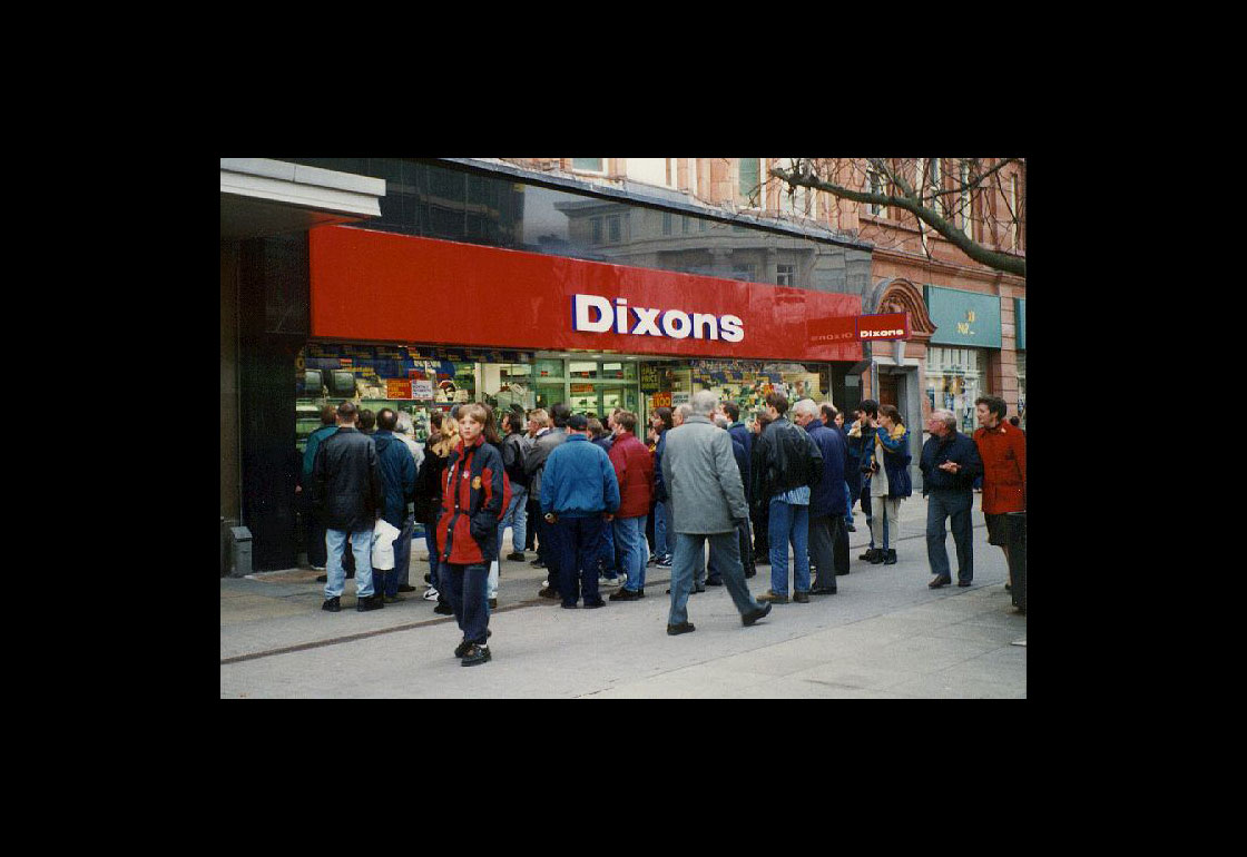 A crowd outside a Dixons store