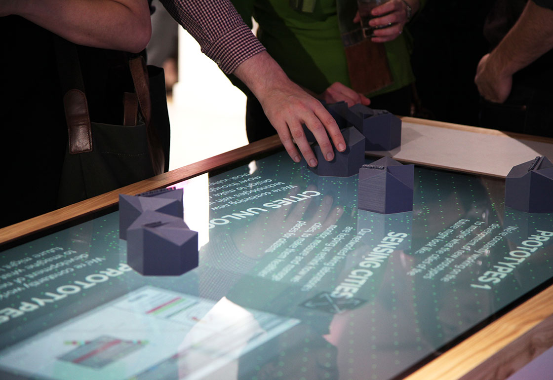 hands on an interactive table with 3D printed objects