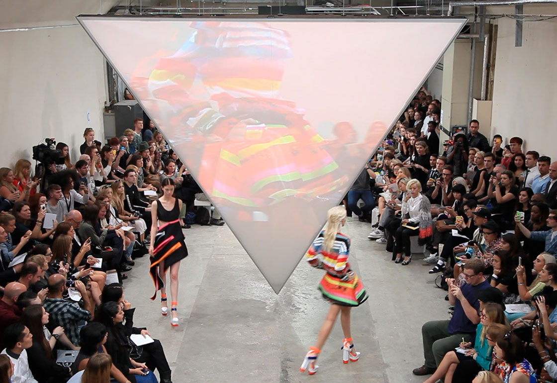 Catwalk show with inverted triangle projection screen