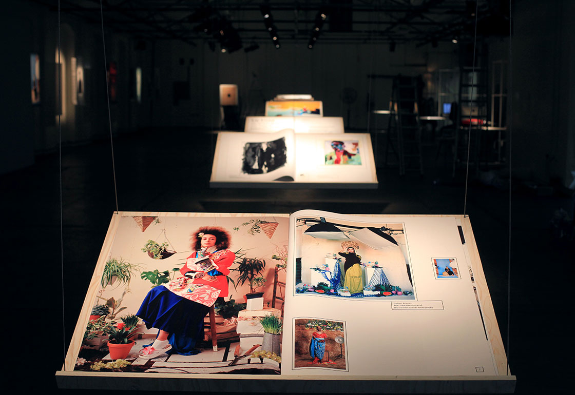 Large books on hanging stands