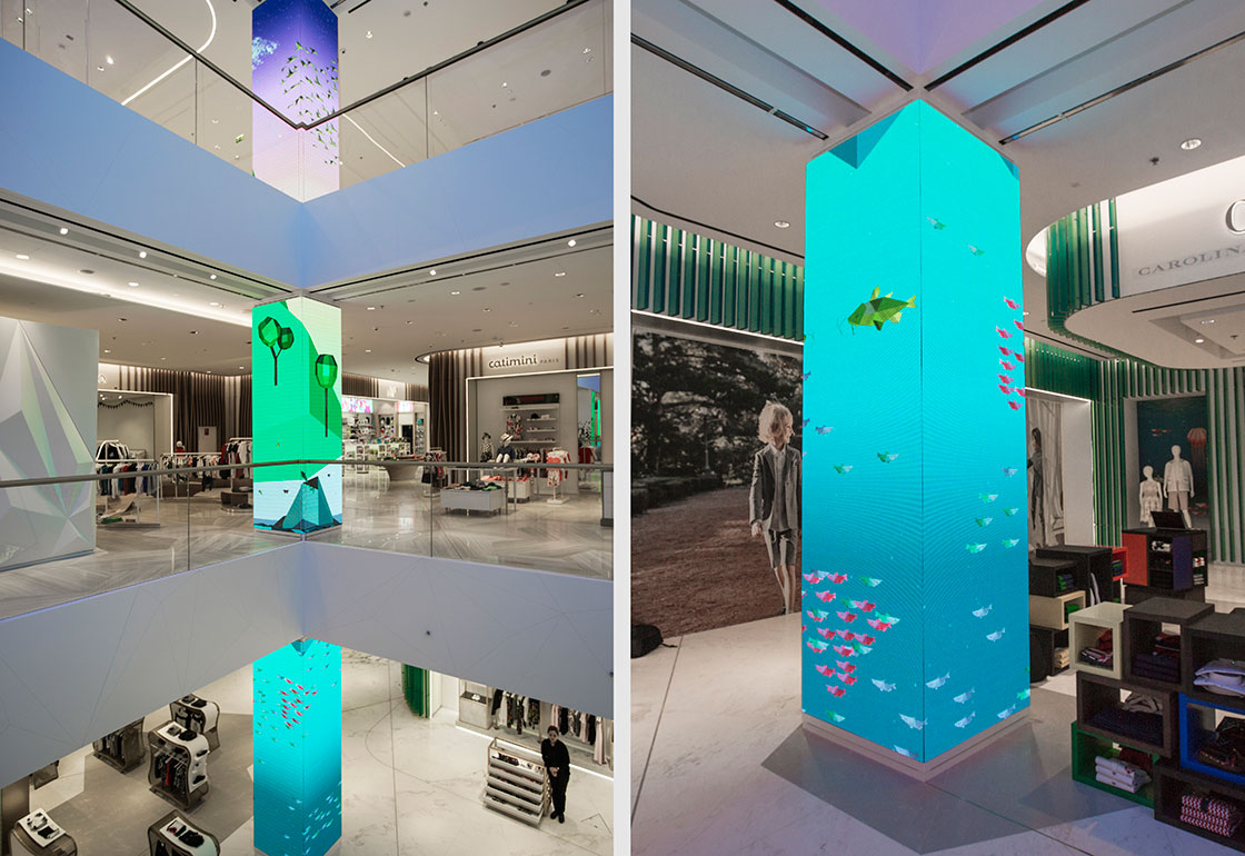 Photo of the store atrium with large screens on the vertical columns