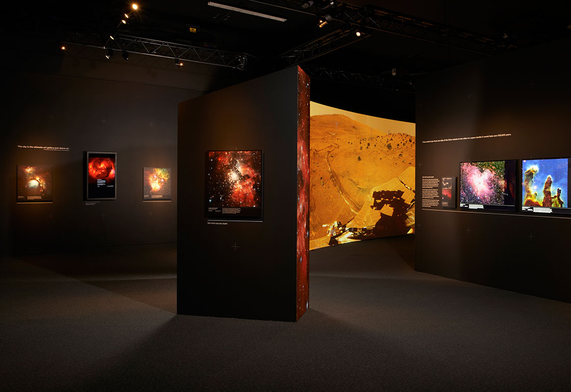 An overview of the exhibition showing colourful space photographs