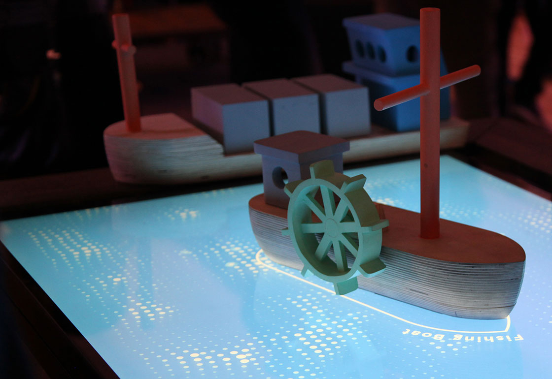 Wooden boat on a touchscreen
