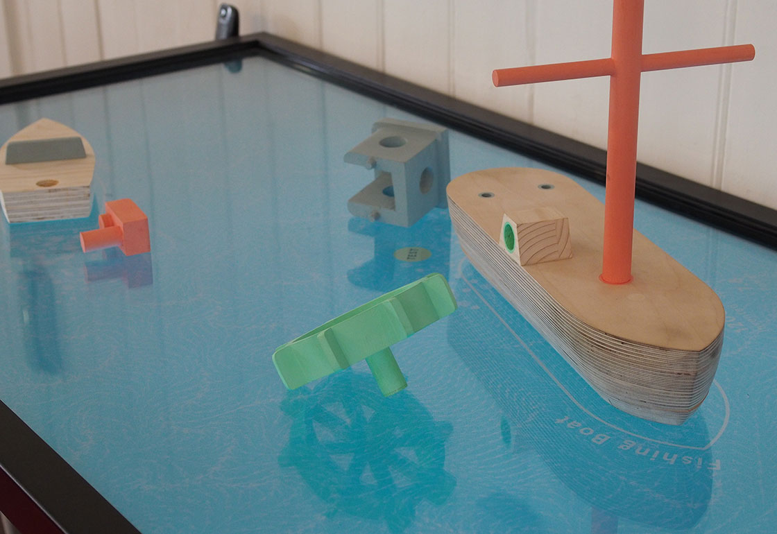 Wooden boat on a touchscreen