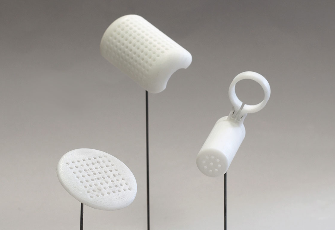 3 white objects on sticks